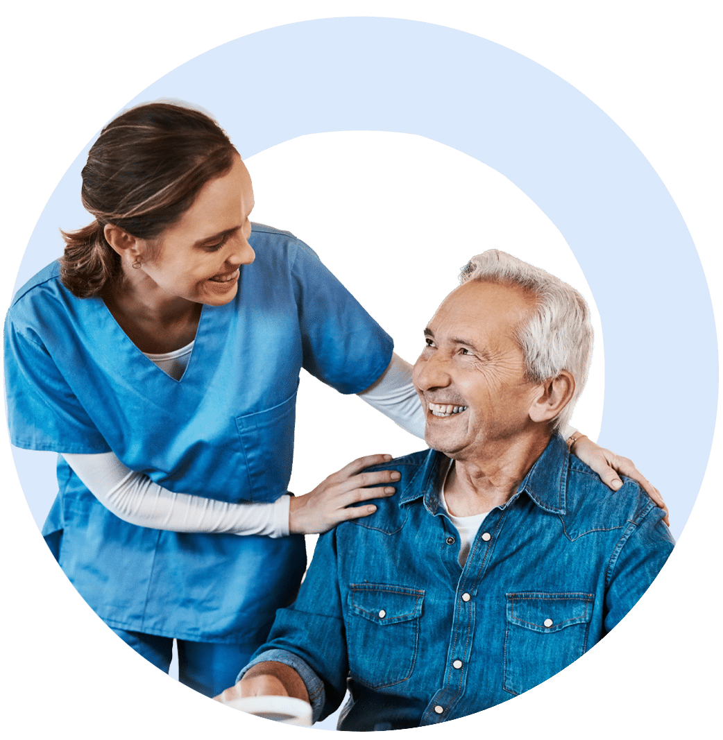 Caregiver smiling with man at breakfast
