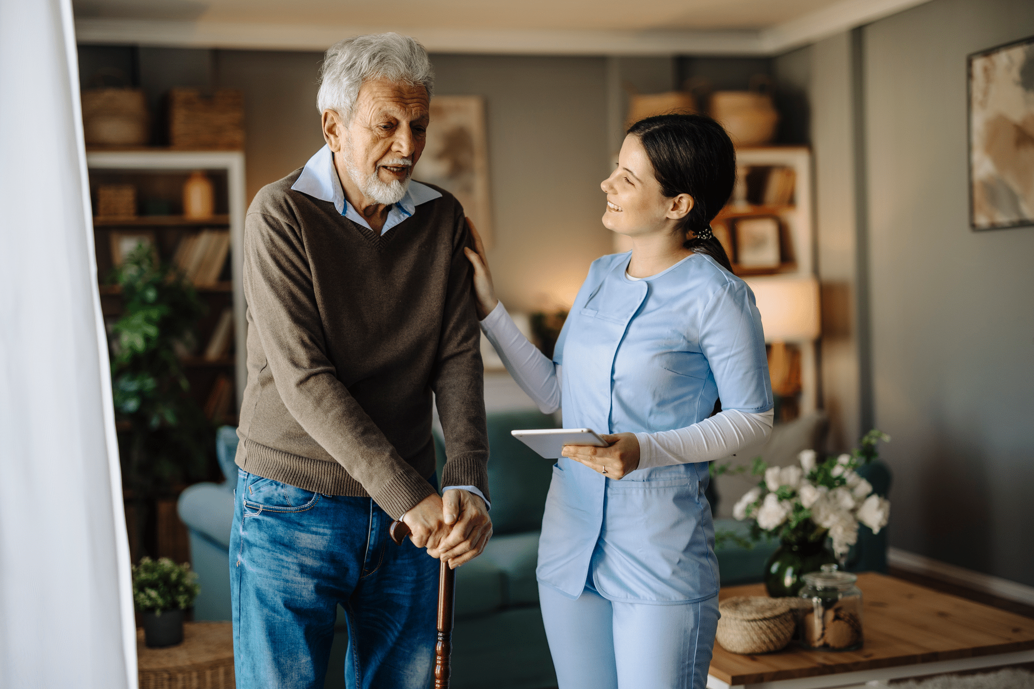 Woman helping man with cane in home